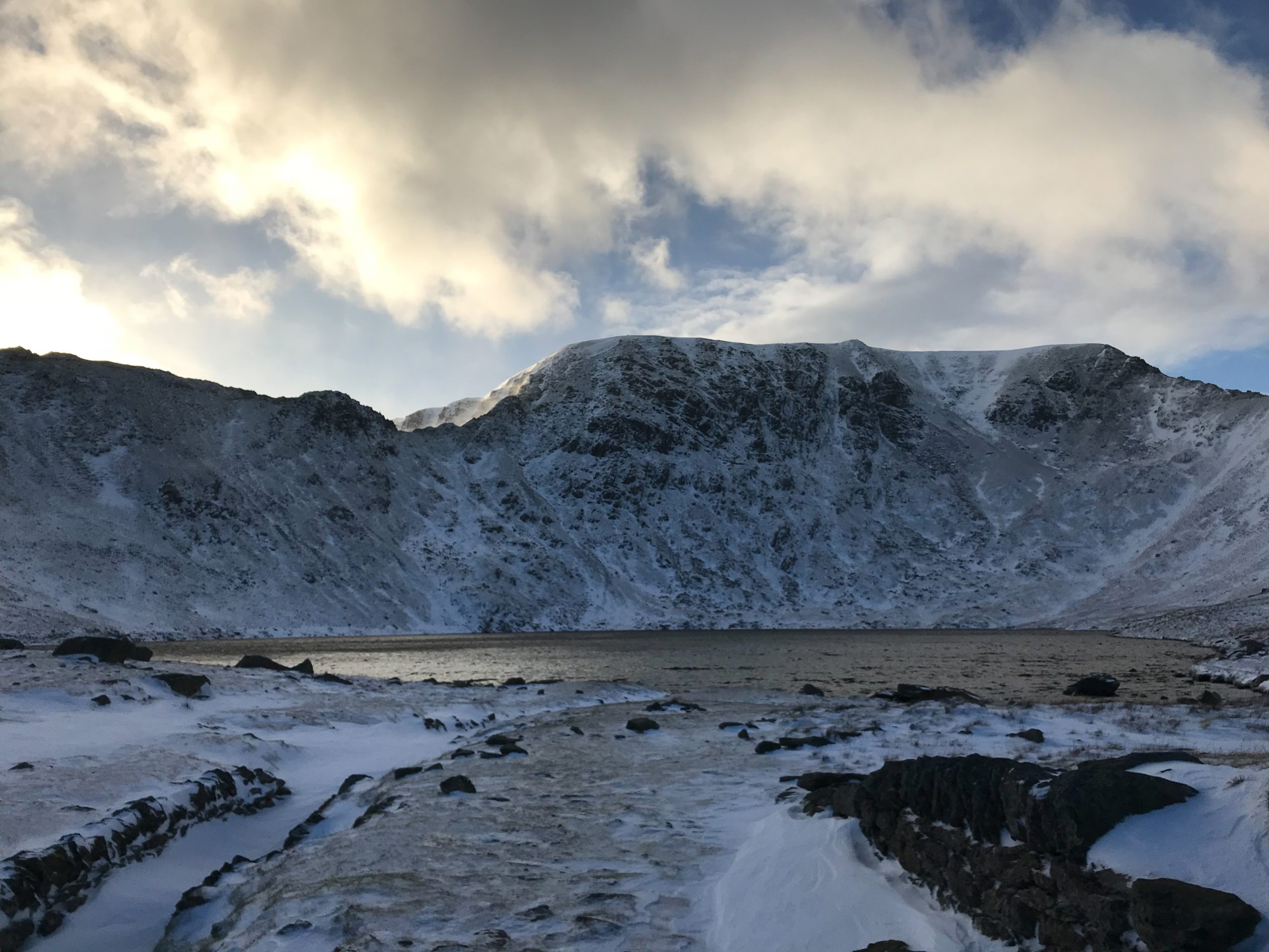 Red Tarn beneath the snow-covered east face of Helvellyn, between Striding Edge and Swirral Edge