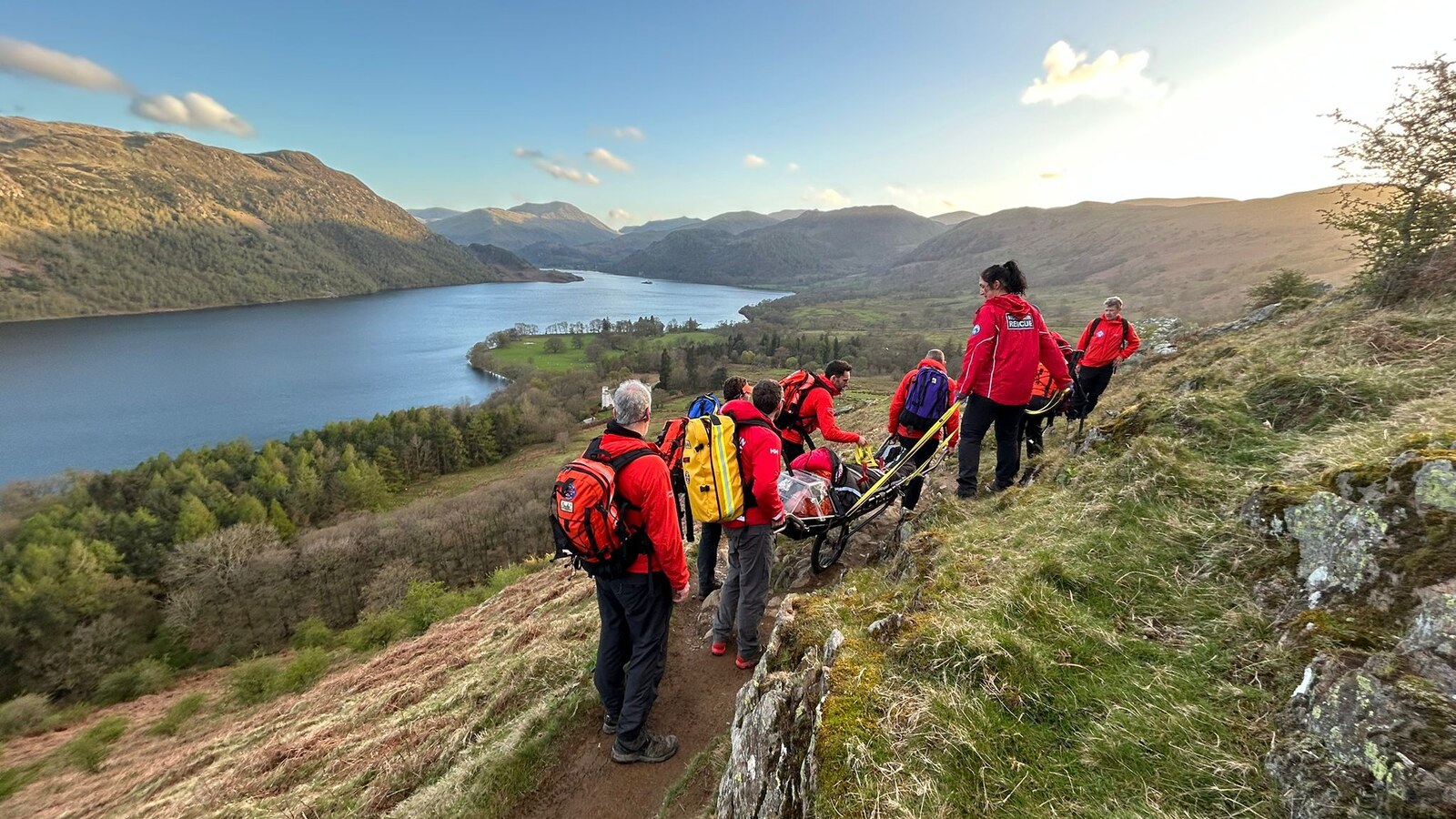 Patterdale MRT members carrying a stretcher down Gowbarrow Fell above Ullswater