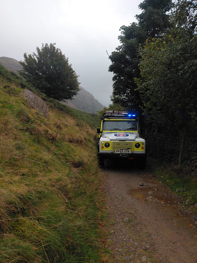 A Patterdale Mountain Rescue Land Rover on a narrow track below the fell