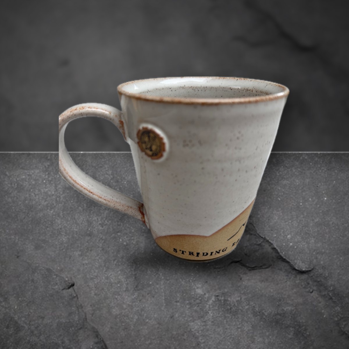 Striding Edge mug, handle side with the team badge