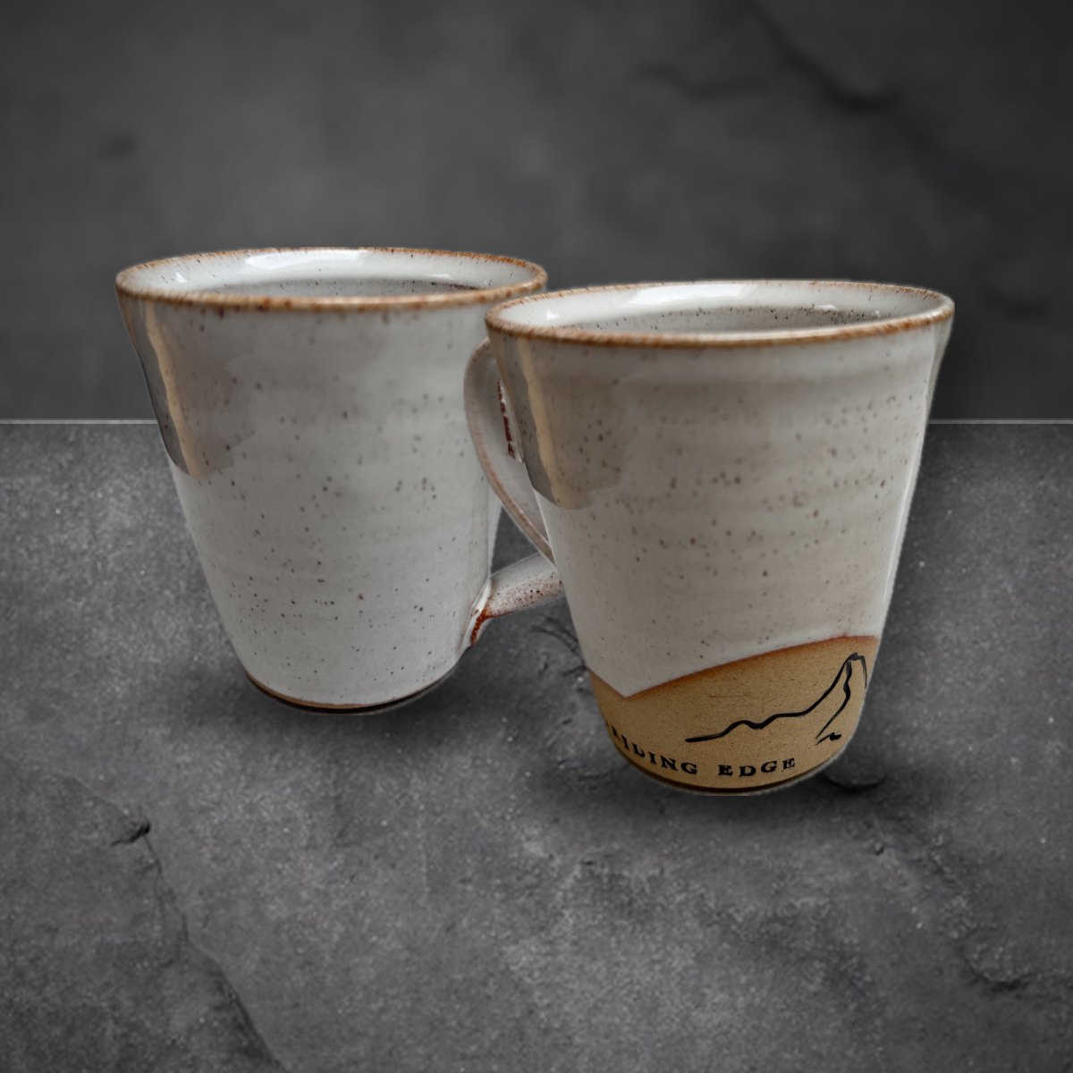 Striding Edge mug and team badge mug together