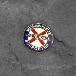 Patterdale Mountain Rescue supporter pin badge on slate