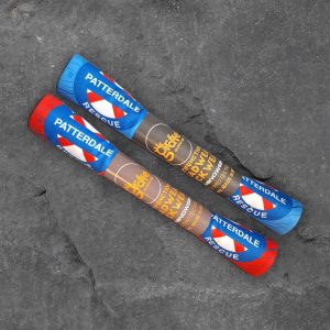 Two Patterdale Rescue Giraffe multifunctional neckwear tubes, one blue and one red, on slate