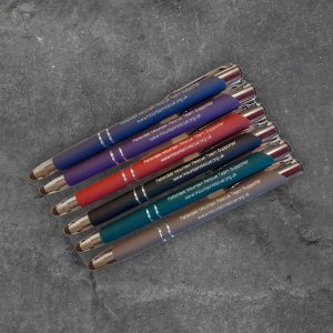 Six Patterdale Mountain Rescue Team supporter stylus pens in assorted colours on slate